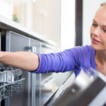 Woman Opening Dishwasher Door