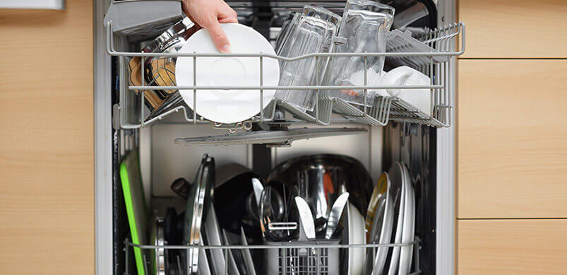 Person Filling Dishwasher