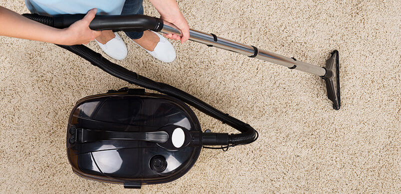 Person Vacuuming Cream Carpet