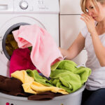 Lady Wrinkling Nose At Smelly Washing Machine