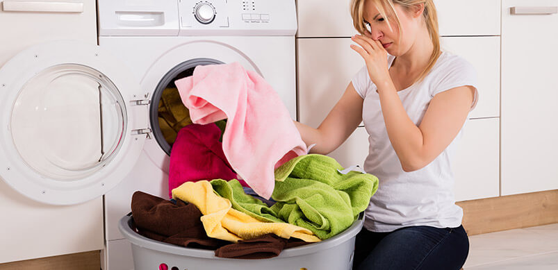 Lady Wrinkling Nose At Smelly Washing Machine