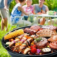 Group Of People Eating Food From The BBQ