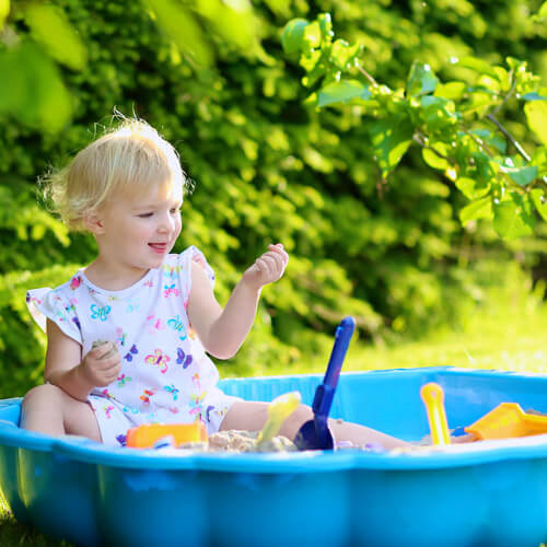 Girl Playing In Sandpit