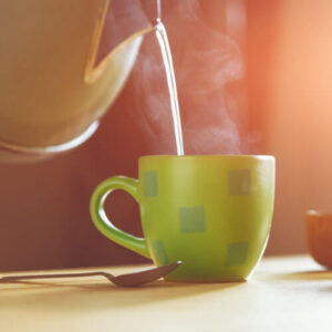 Kettle Pouring Water Into Teacup