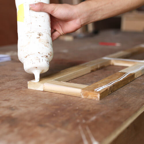 Applying Wood Glue To A Piece Of Wood