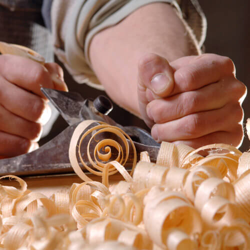 Man Planing A Piece Of Wood