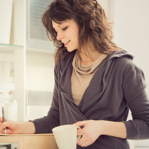 Woman Drinking Tea And Writing