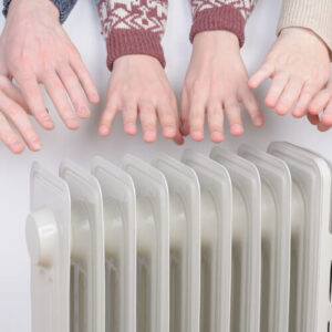 Family Warming Hands On Electric Heater In Winter