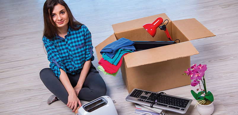 Woman Packing Toaster And Other Small Electricals