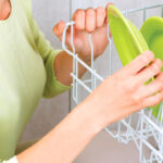 Woman Loading The Dishwasher