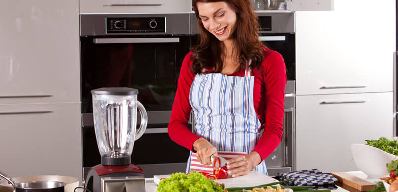 Woman Preparing Dinner In Kitchen