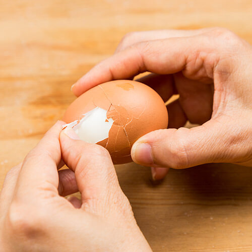 Boiled Egg Being Peeled