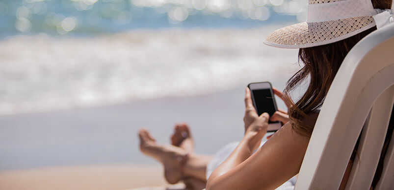 Woman On Phone On The Beach