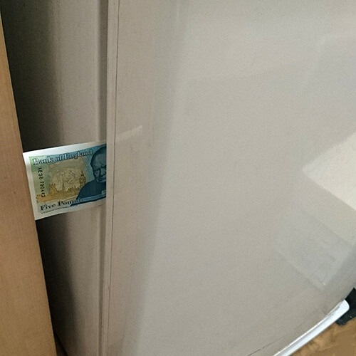 Fridge Door Seal Holding Five Pound Note