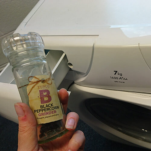 Pepper Held Over Washing Machine Drawer