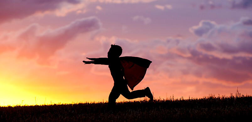 Silhouette Of Child Pretending To Have Flying Superpower