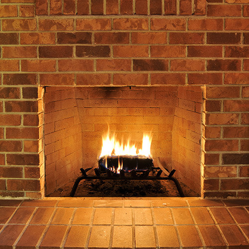 Brick Fireplace With Fire On