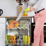 Woman Removing Bowls From Dishwasher