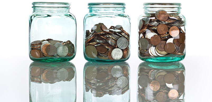 Three Glass Jars Filled With Coins