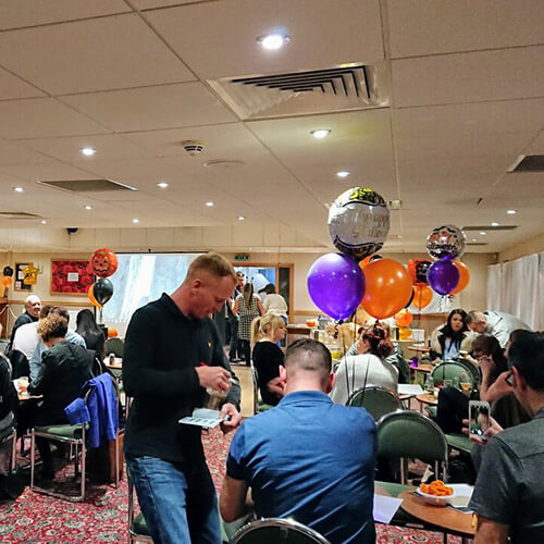 Tables Of People At Quiz Night