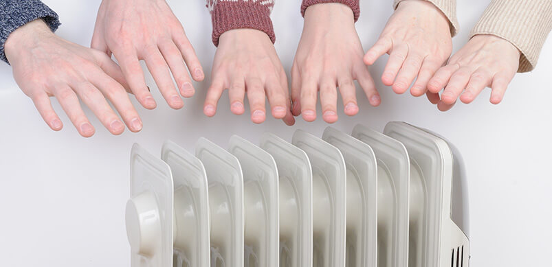 Hands Warming Over Electric Heater