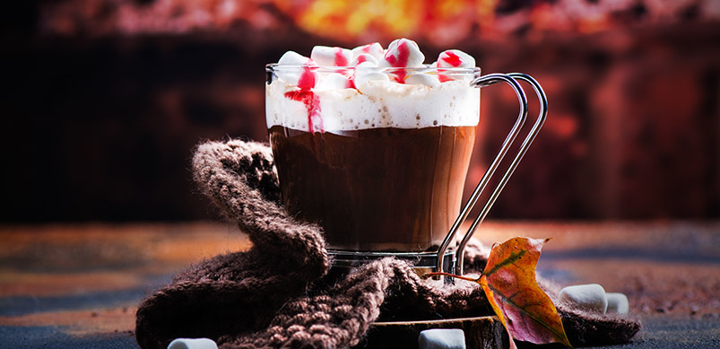 Hot Chocolate With Cream Next To Fireplace