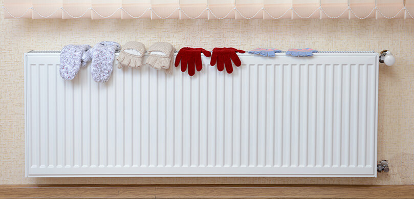 Knitted Gloves Drying On Radiator