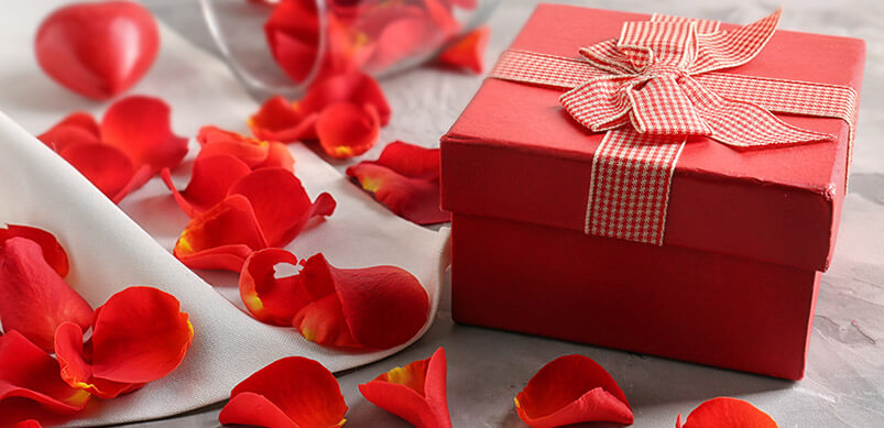 Red Gift Box With Scattered Red Rose Petals