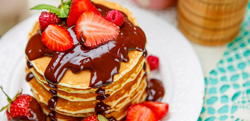 Stack Of Pancakes With Chocolate And Strawberries