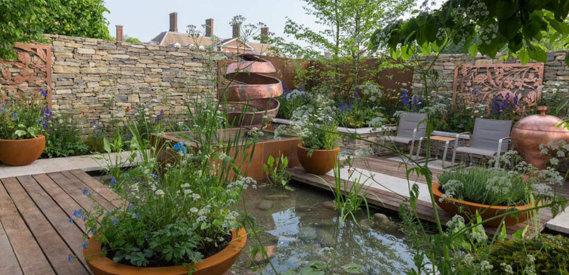 Water Feature Surrounded By Potted Plants