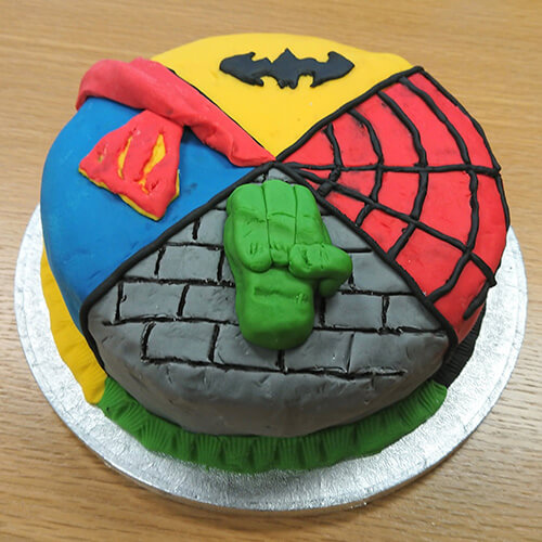 Cake With Superhero Theme On Each Corner