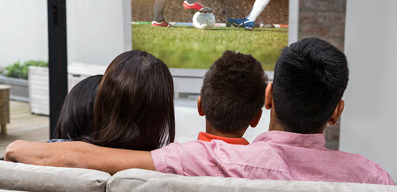 Family On Sofa Watching TV 