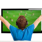 Man Watching football On TV With Arms Up