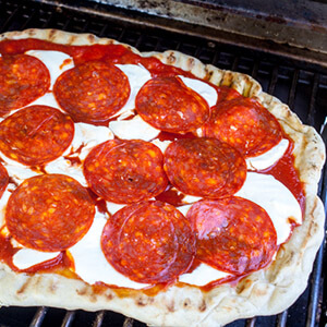 Pizza On BBQ With Cheese And Pepperoni