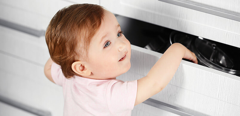 Child Playing With Open Drawer