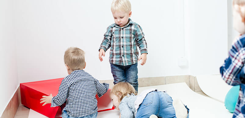 Group Of Children Playing With Open Bag