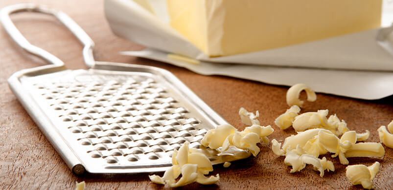 Grated Butter On Wooden Board