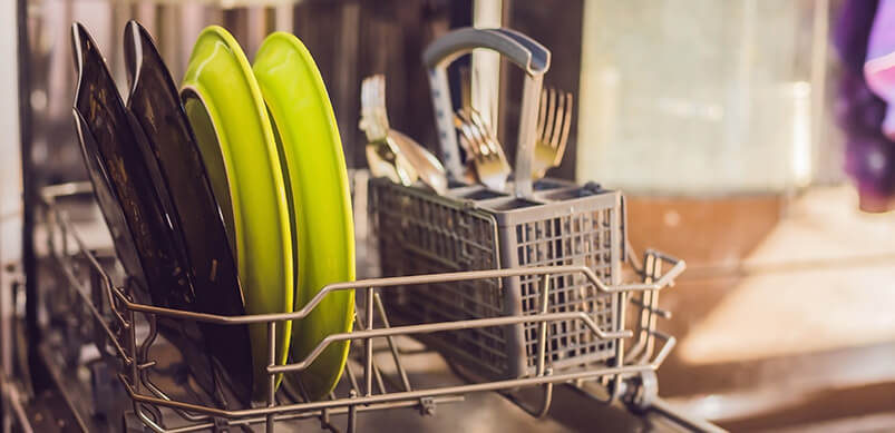 Dishwasher Looking Empty With A Few Plates And Cutlery