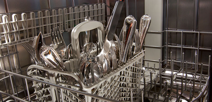 Close Up On Cutlery Inside Dishwasher