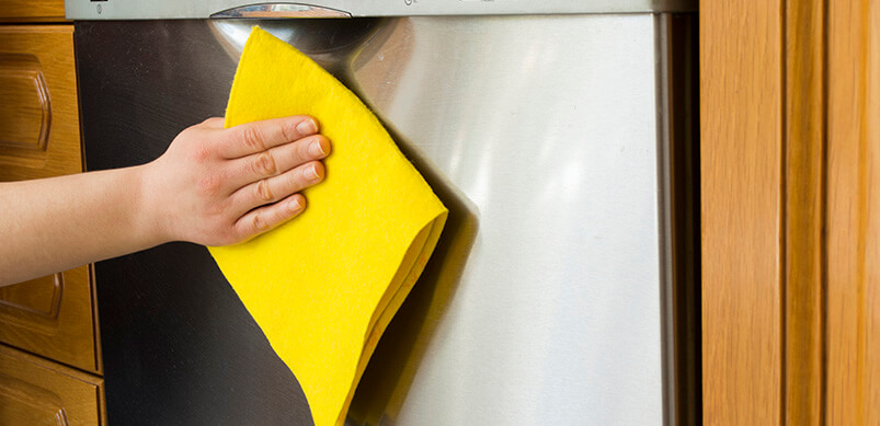 Close Up On Hand Holding Cloth To Clean The Dishwasher