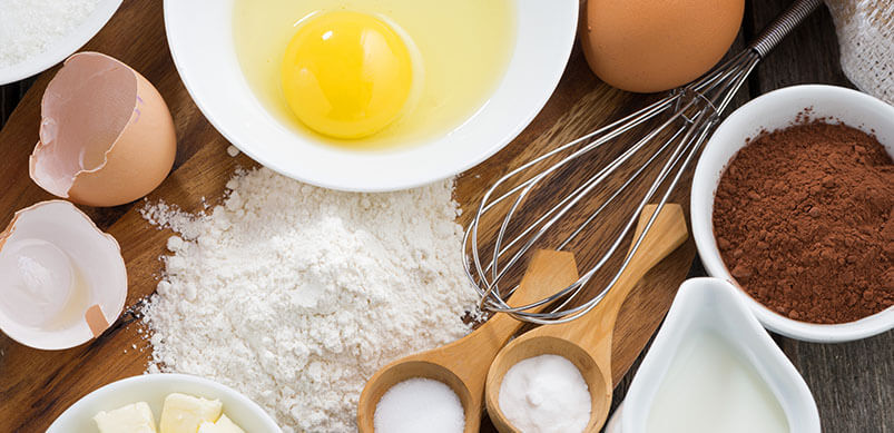 Baking Ingredients And Equipment On Wooden Board