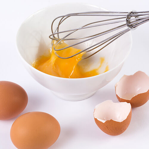 Bowl With Eggs And Whisk