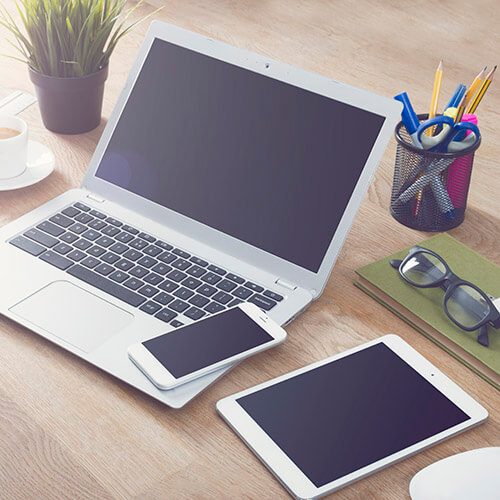 Computer Phone And Tablet On Desk