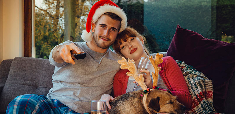 Couple Watching TV With Dog