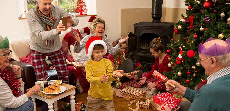 Family Gathered Round At Christmas