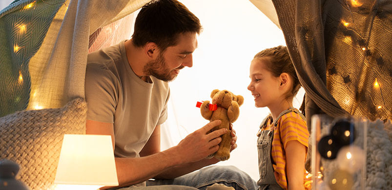 Father Playing With Daughter And Her Toys