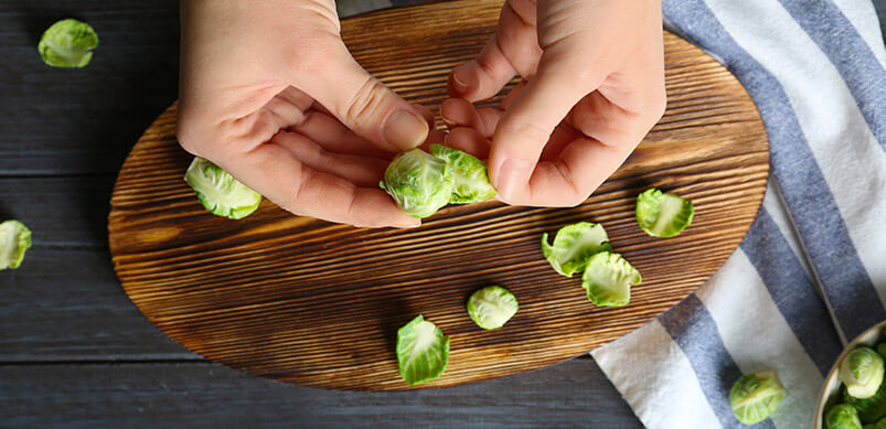 Hands Peeling Brussels Sprouts