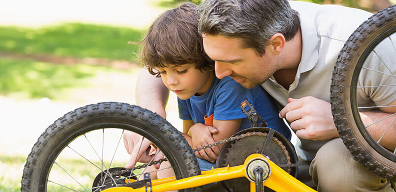 Dad Teaching Son To Fix Bike