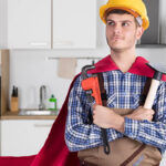 Man In Cape Holding Work Tools