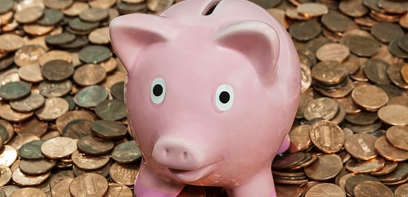 Piggy Bank On Top Of Pile Of Pennies